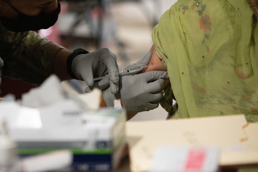 Afghan evacuees are vaccinated at Fort Bliss' Doña Ana complex