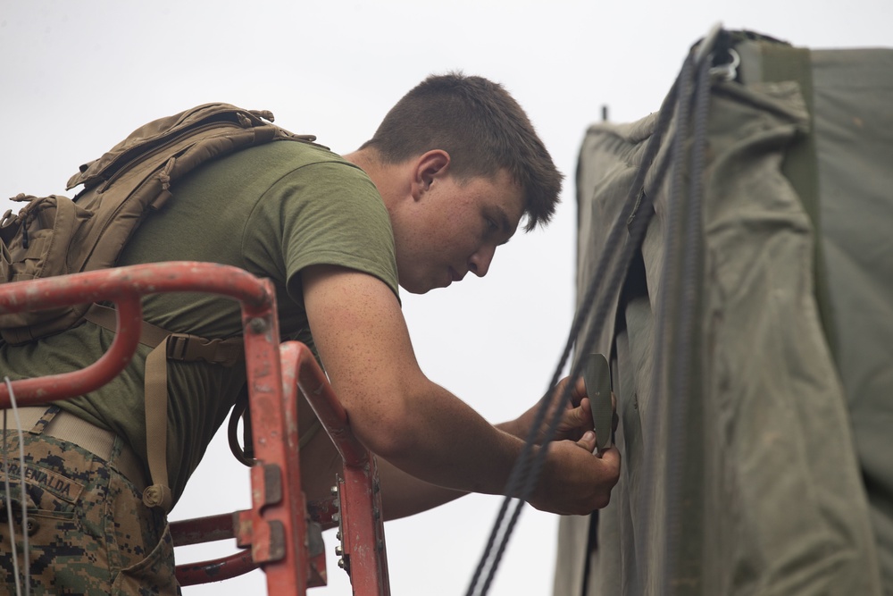 Marine from 8th Engineer Support Battalion Repairs Tents