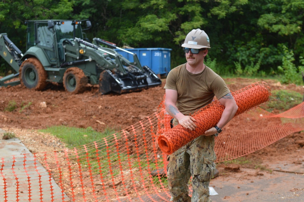 NMCB One DET Guam Seabee installs new snow around the Outhouse project