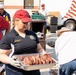 Volunteers serve military members BBQ lunch
