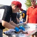 Volunteers serve military members BBQ lunch