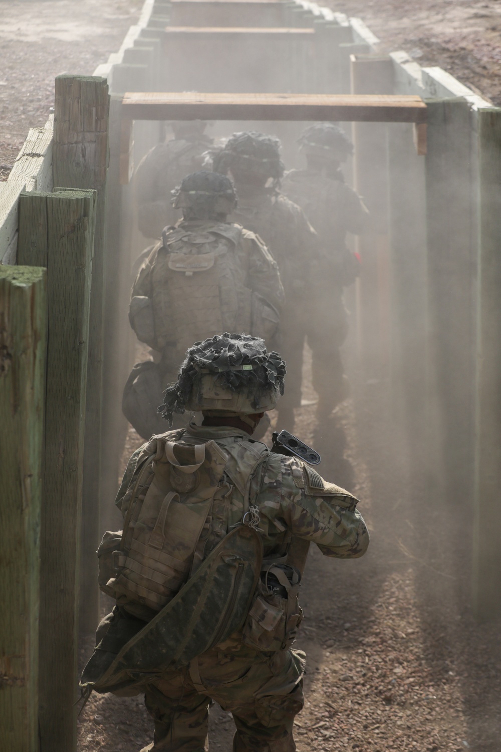 Dismounted squad moves through a trench during platoon live fire training