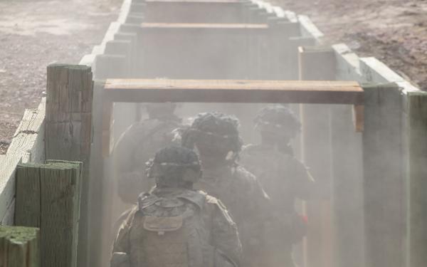Dismounted squad moves through a trench during platoon live fire training