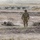 Dismounts throw simulated grenades into a trench