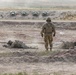 Dismounts throw simulated grenades into a trench