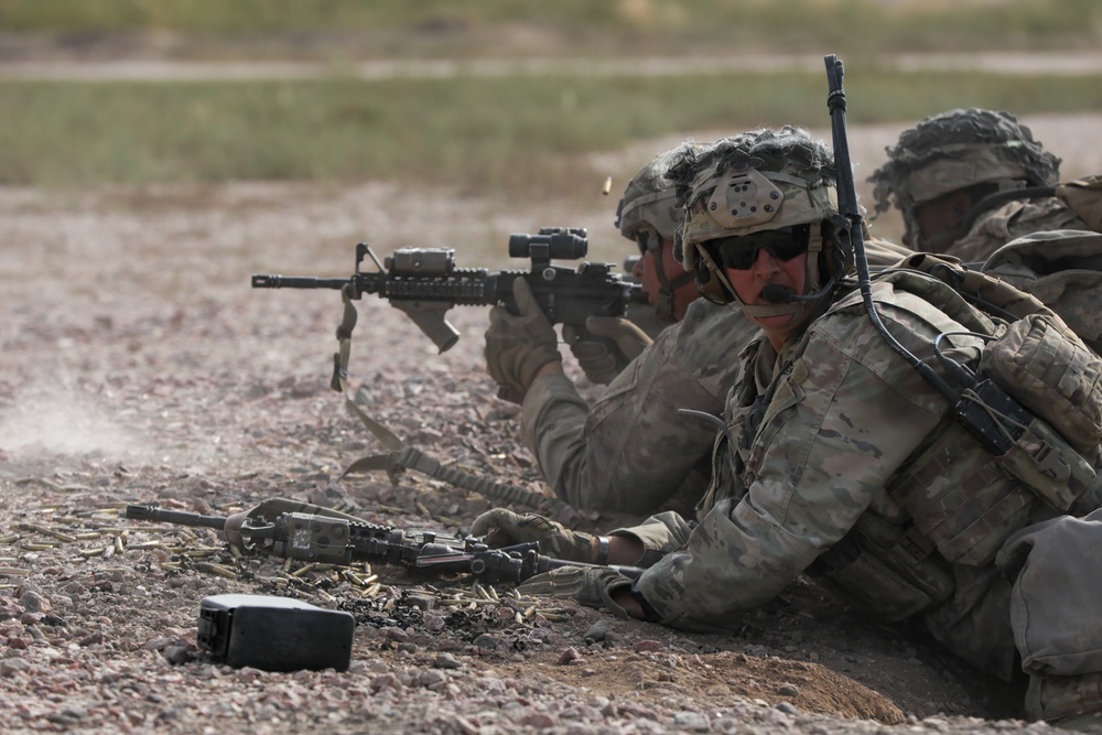 A dismounted infantry team fires on enemy targets during platoon live fire exercises.