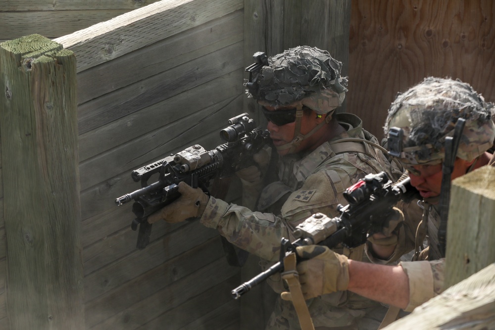 Riflemen advance through a trench during platoon live fire exercises