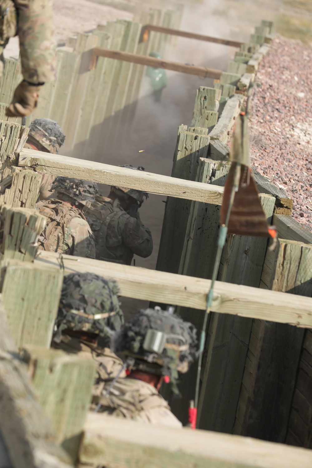 Dismount squad advances through a trench during platoon live fire exercises