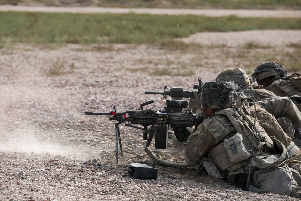 A dismounted team fires on enemy targets during platoon live fire exercises