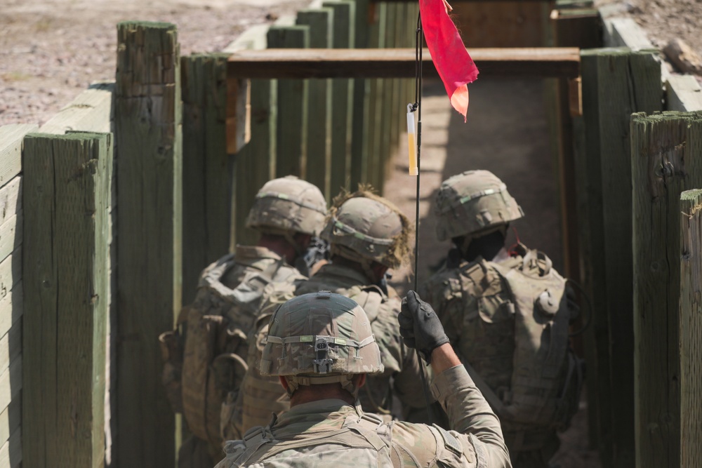 Dismounted team advances through a trench during platoon live fire exercises