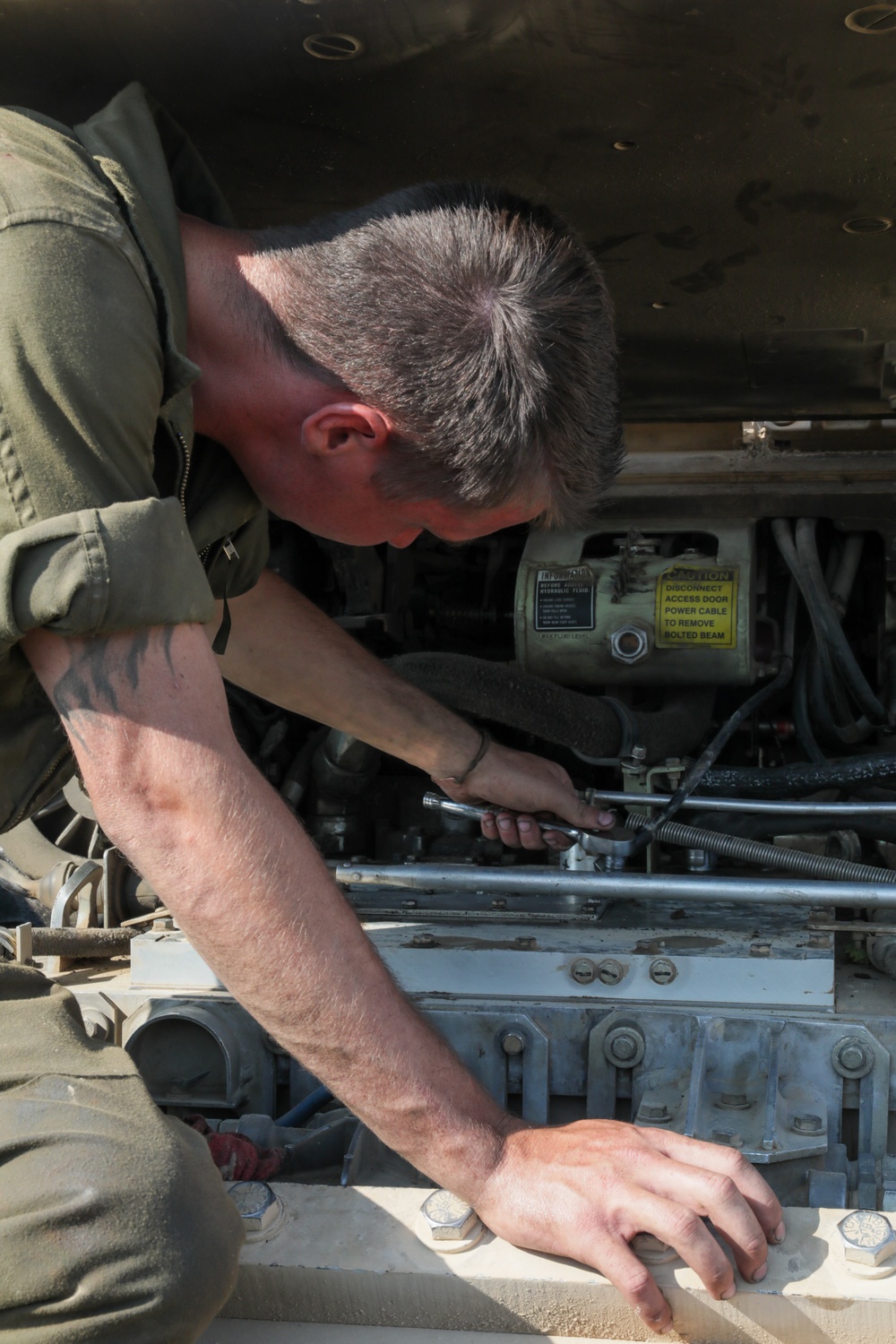 Mechanic trouble shoots issues within an M2A3 Bradley engine