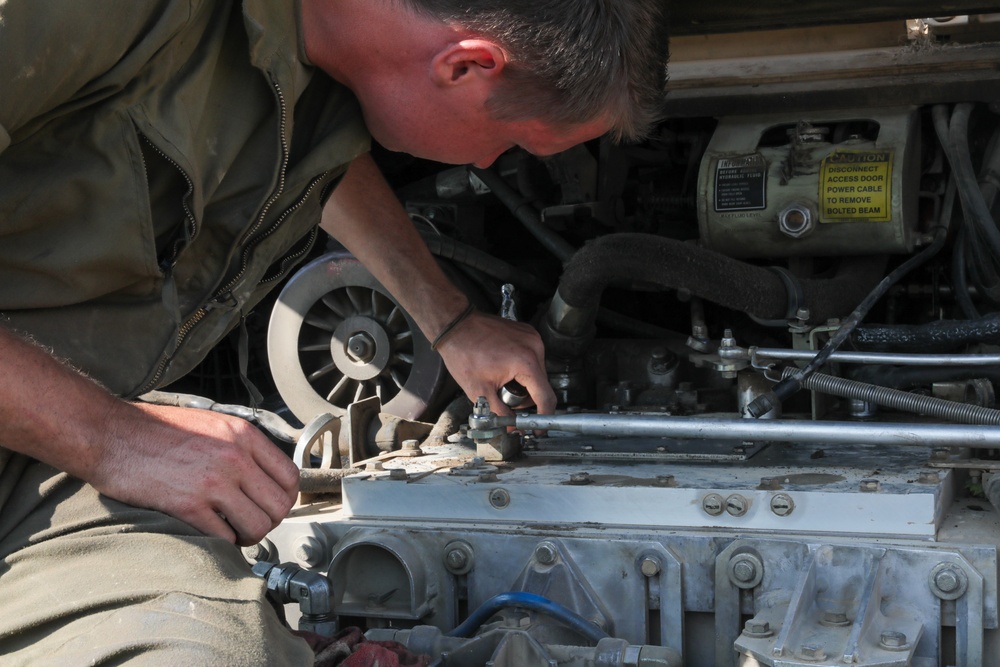 Mechanic trouble shoots issues within an M2A3 Bradley engine