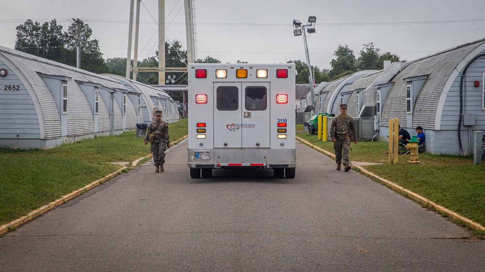 U.S. Marines Guide an Ambulance Through Temporary Housing