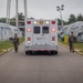 U.S. Marines Guide an Ambulance Through Temporary Housing