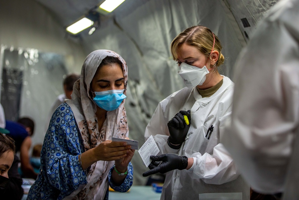 U.S. service members at Fort Pickett provide medical screening and vaccinations to Afghan civilians