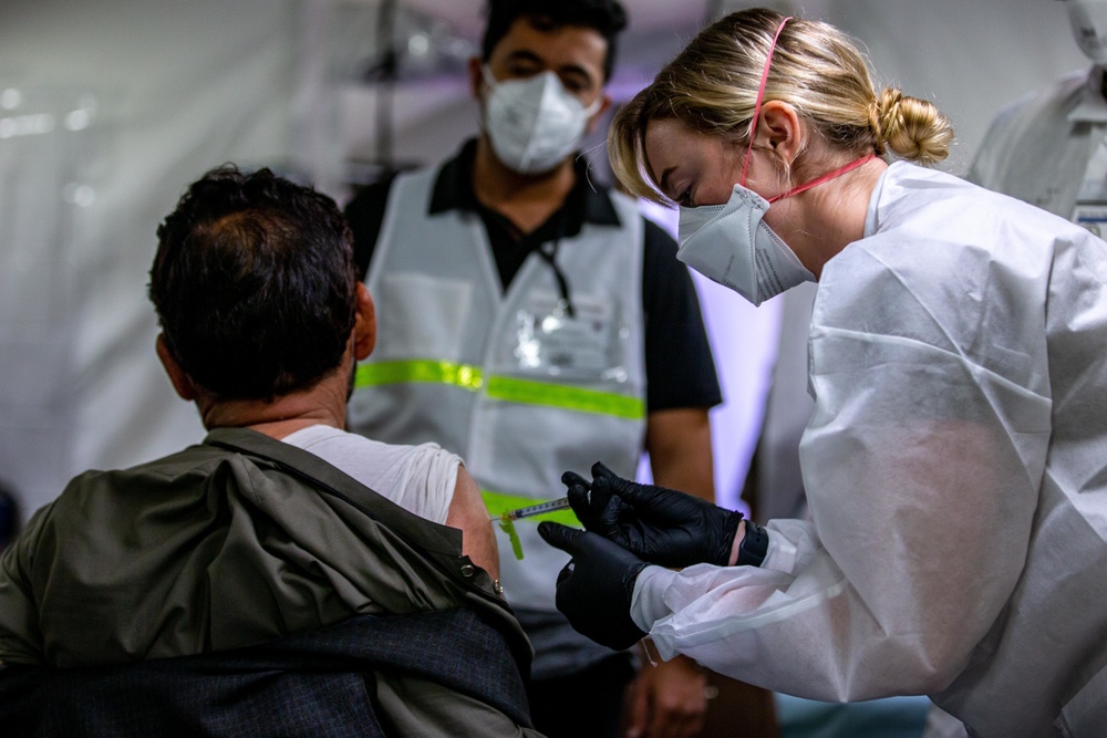 U.S. service members at Fort Pickett provide medical screening and vaccinations to Afghan civilians