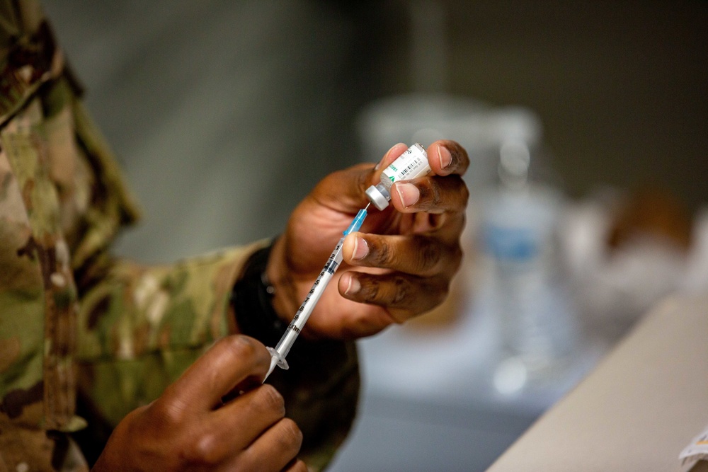 U.S. service members at Fort Pickett provide medical screening and vaccinations to Afghan civilians