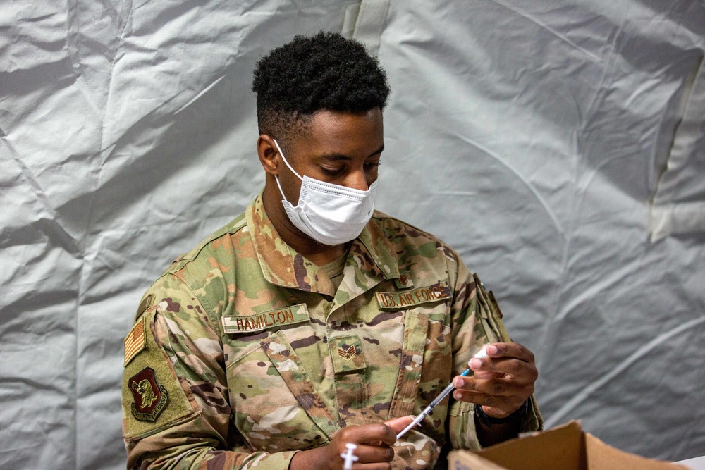 U.S. service members at Fort Pickett provide medical screening and vaccinations to Afghan civilians