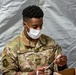 U.S. service members at Fort Pickett provide medical screening and vaccinations to Afghan civilians