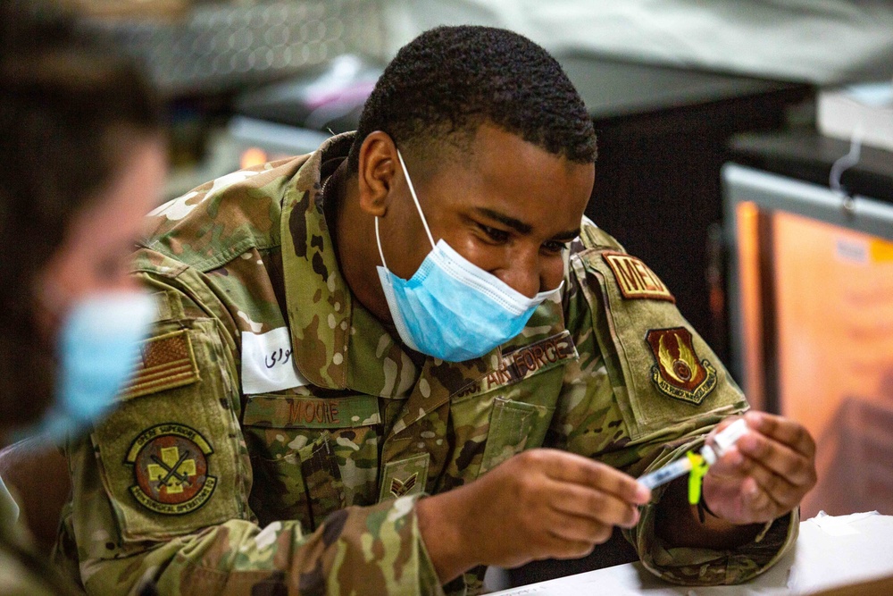 U.S. service members at Fort Pickett provide medical screening and vaccinations to Afghan civilians