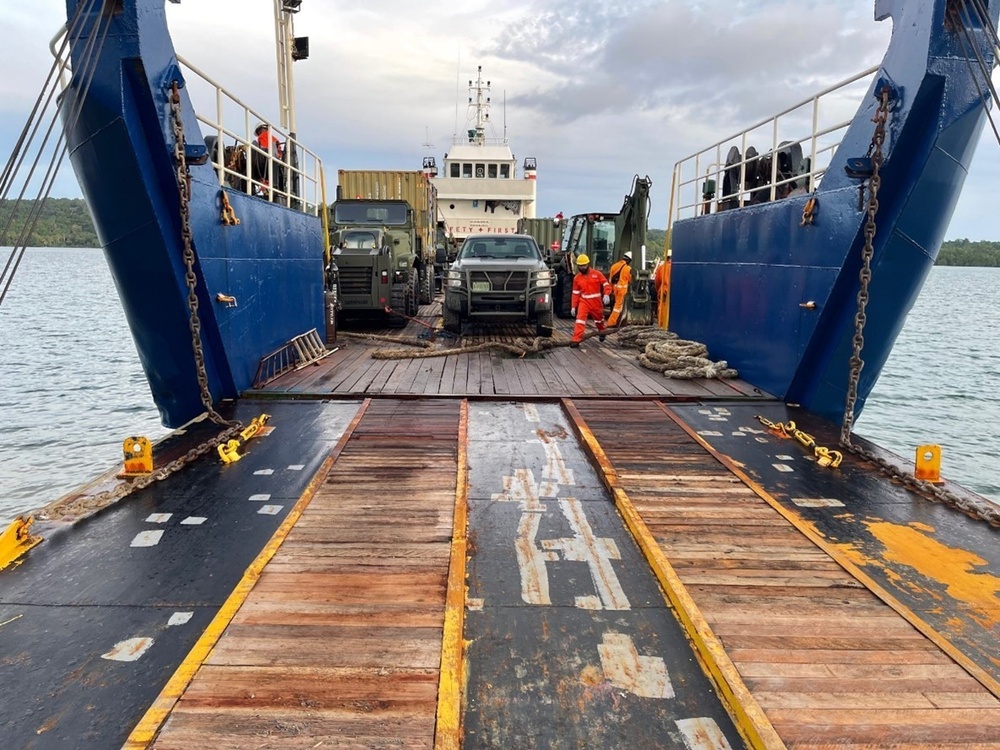 U.S. Navy Seabees assigned to NMCB-5 receive civil engineer support equipment at Papua New Guinea