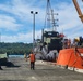 U.S. Navy Seabees assigned to NMCB-5 receive civil engineer support equipment at Papua New Guinea