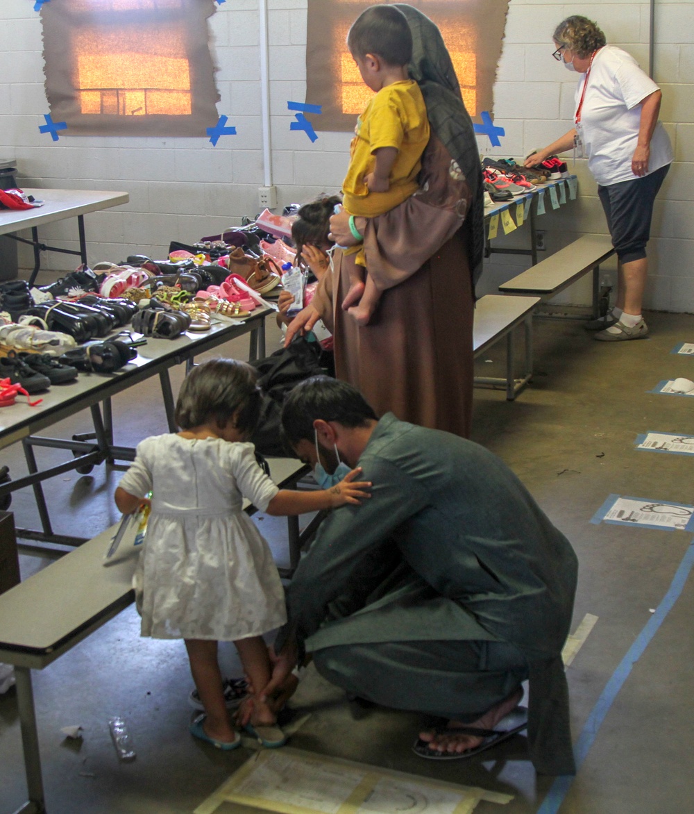 Volunteers pass out donations to Afghan guests