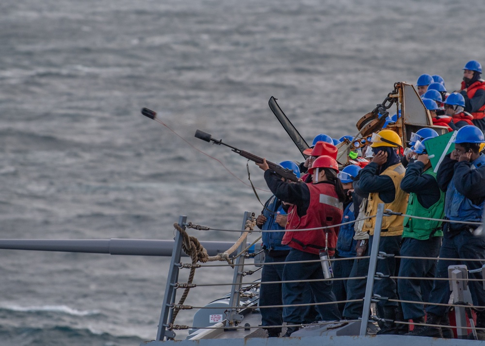 USS Mustin Sailor Fires a Shot Line During Replenishment-At-Sea