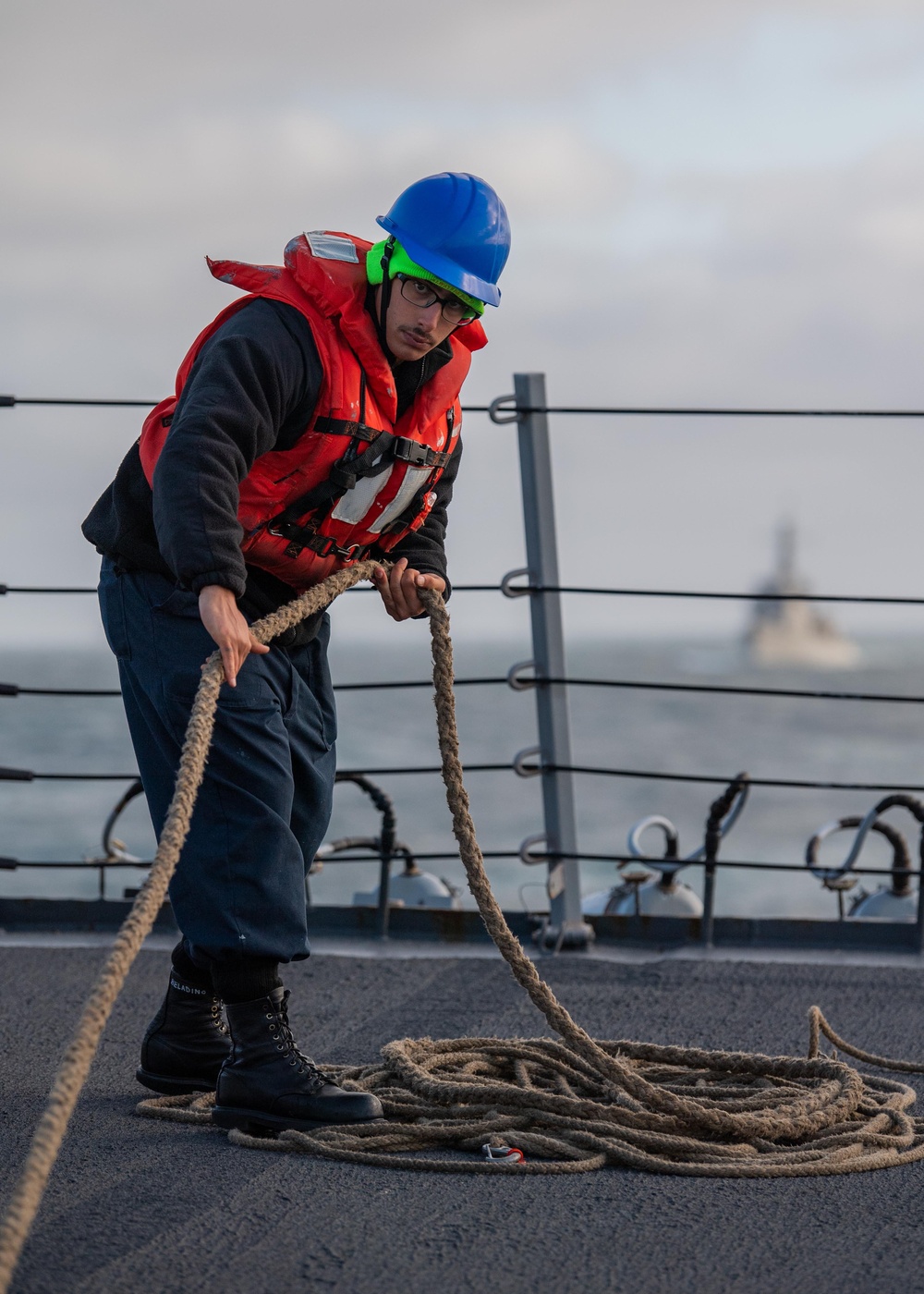 USS Mustin Sailor Coils Line During a Replenishment-At-Sea