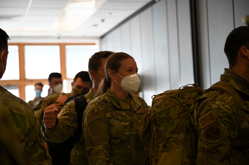 U.S. Airmen arrive at RAF Mildenhall after returning from a deployment
