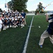 Paul Duddy photographs football players at the Coast Guard Academy