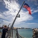 USS Billings Sailor Raises Ensign During Sea and Anchor Detail