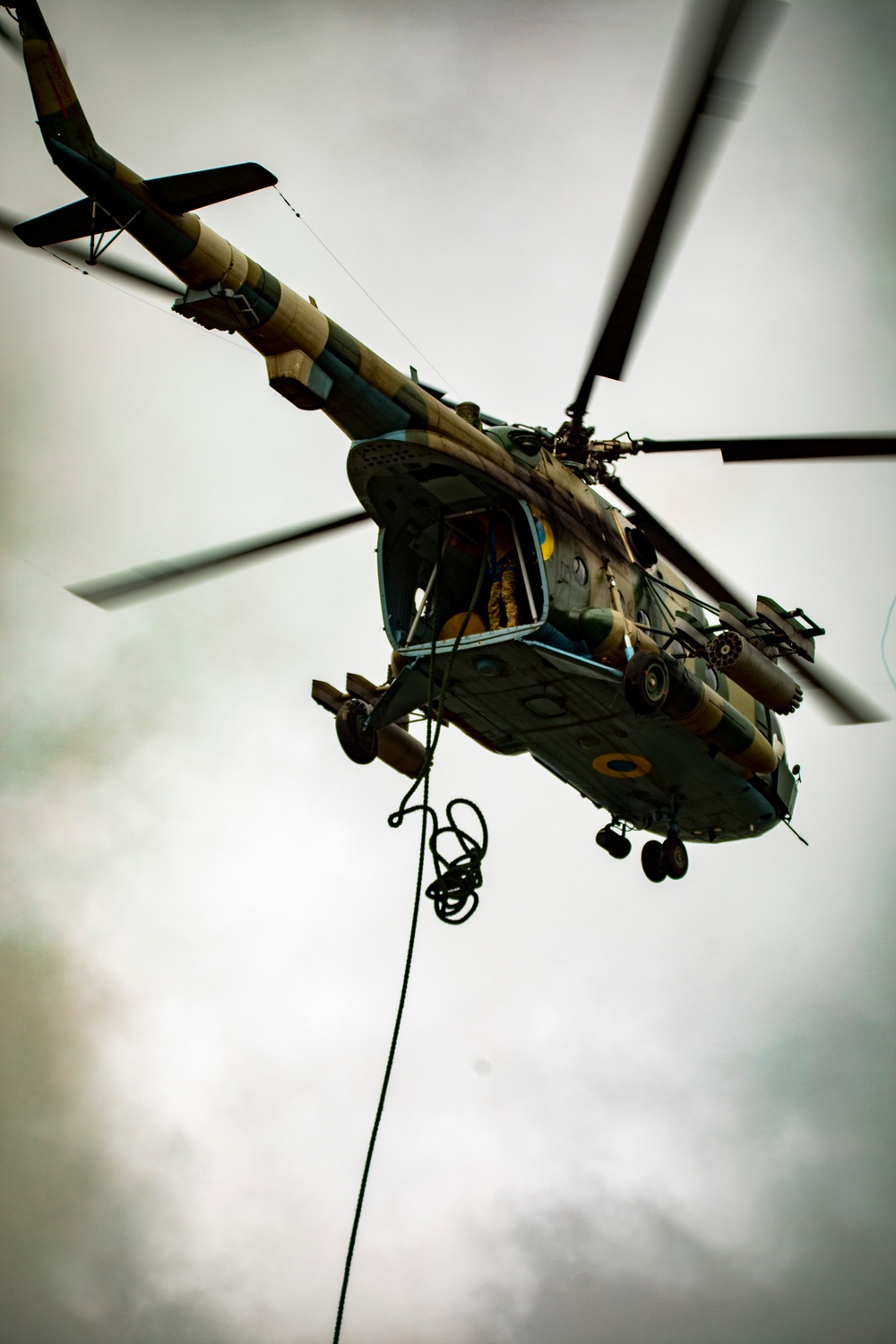 Ukrainian soldiers fast rope from a MI-8 helicopter
