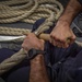 USS Billings Sailor Splices and Repairs Line