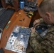 81st SBCT S6 Soldier repairs computer while deployed in Ukraine