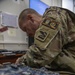 81st SBCT S6 Soldier repairs computer while deployed in Ukraine