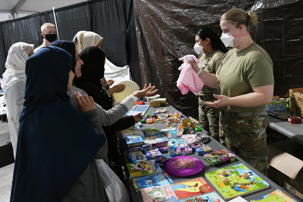 Afghan kids enjoy Books, Puzzles and toys at the new Task Force Liberty clothing distribution