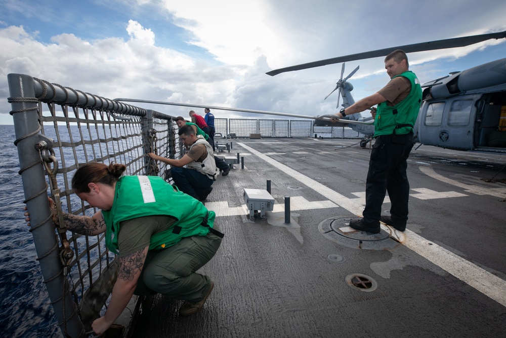 USS Sioux City Sailors Lower Flight Deck Nets Prior to Conducting Flight Ops