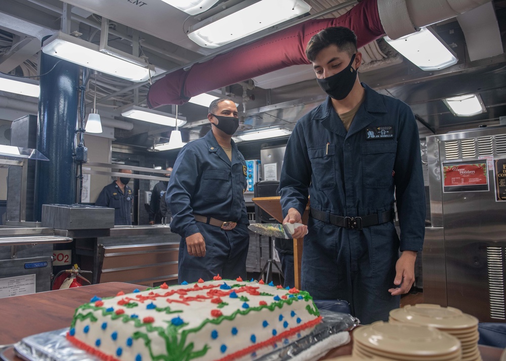 USS Mustin Sailor Cuts a Cake During Hispanic Heritage Celebration