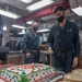 USS Mustin Sailor Cuts a Cake During Hispanic Heritage Celebration