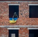 Ukrainian soldier puts flag on cleared building during Rapid Trident 21