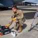 A Reservist services oil to a C-17 Globemaster III