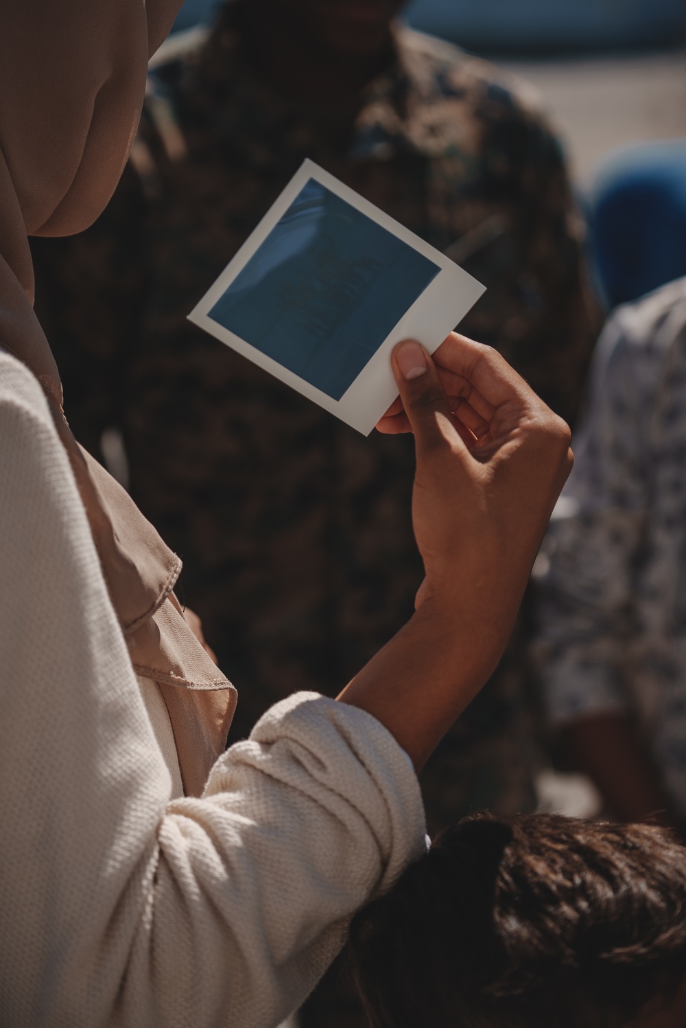 US Marines take Polaroid photos with Afghan Individuals on Fort Pickett