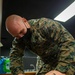 U.S. Navy Corpsmen organize Afghan medical files on Task Force Quantico