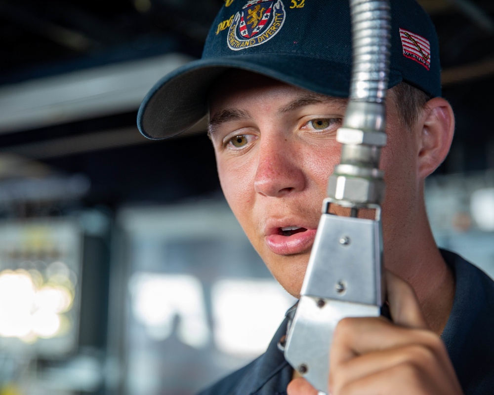 SN Kaleb Hall Responds to a New Course from the Pilot House aboard USS Barry