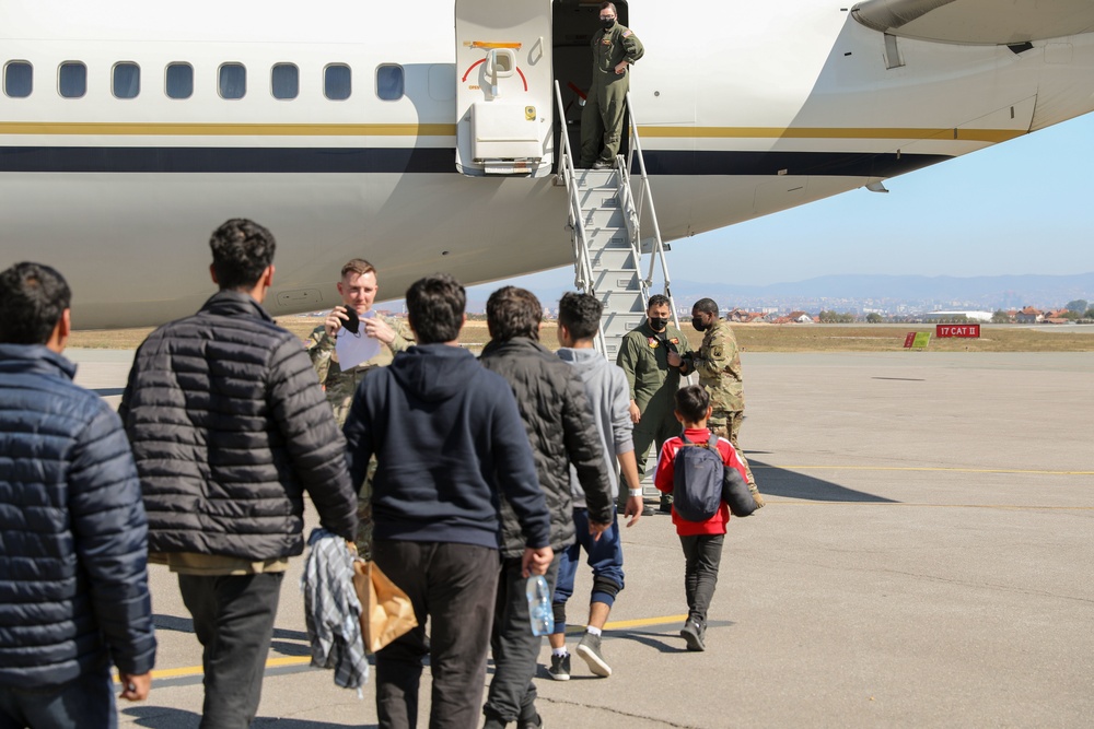 Afghan Travelers prepare to board a flight bound for the United States