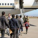 Afghan Travelers prepare to board a flight bound for the United States