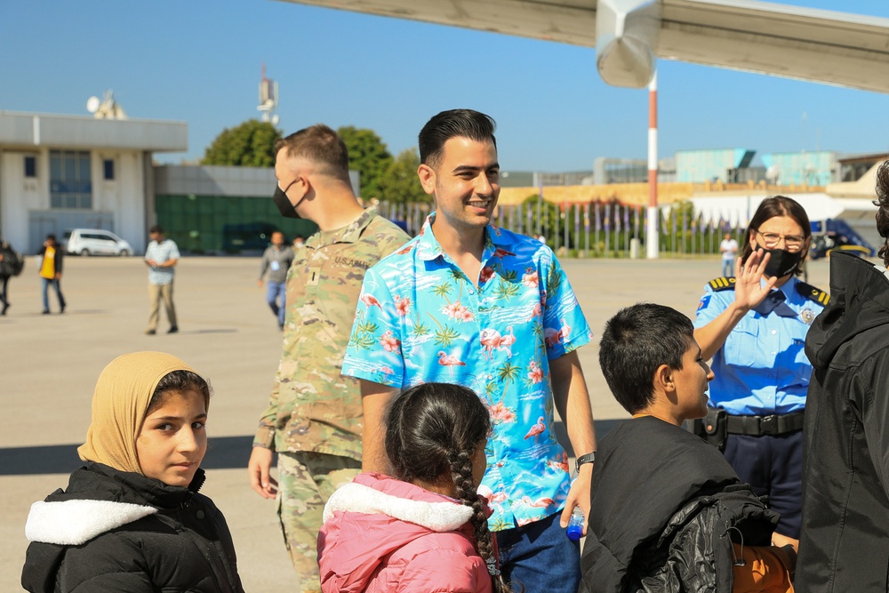 Afghan Travelers prepare to board a flight bound for the United States