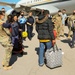 Afghan Travelers prepare to board a flight bound for the United States