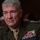 SECDEF, CJCS, CENTCOM Senate Armed Services Testimony A senior U.S. Marine Corps officer in dress uniform is seated, appearing to be at a formal hearing or official proceeding. He wears a large array of service ribbons and medals on his left chest, along with what appear to be four-star rank insignia on his shoulders. His expression is serious and attentive.